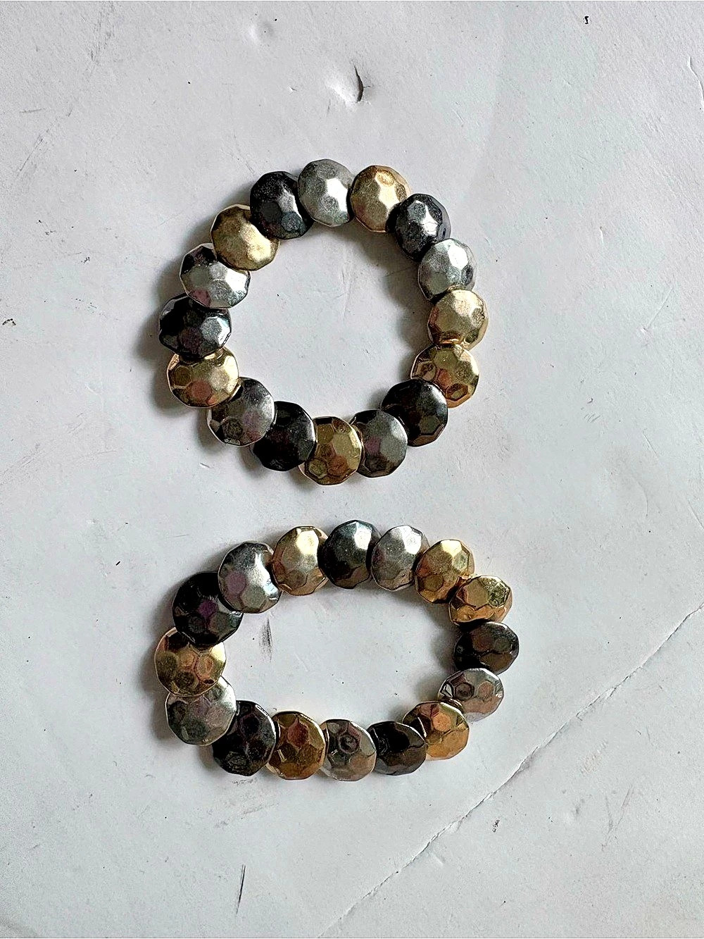 A pair of Stretch Bracelets in Black & Gold and silver
